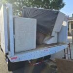 Piano removal Los Angeles - Rapid Junk Pros crew hauling an upright piano