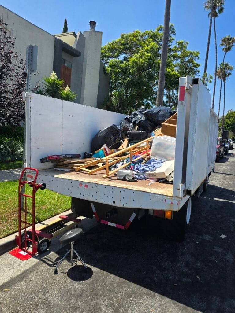 Junk Removal Tips for Los Angeles Homeowners and Businesses 4 Truck bed loaded with wood pieces and bags at the curb on a residential street