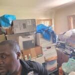 Rapid Junk Pros crew member in a room stacked with boxes before a cleanout