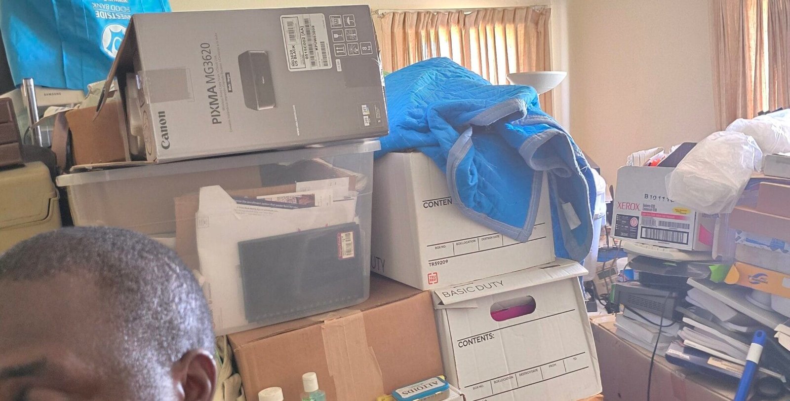Junk Removal Tips for Los Angeles Homeowners and Businesses 1 Rapid Junk Pros crew member in a room stacked with boxes before a cleanout